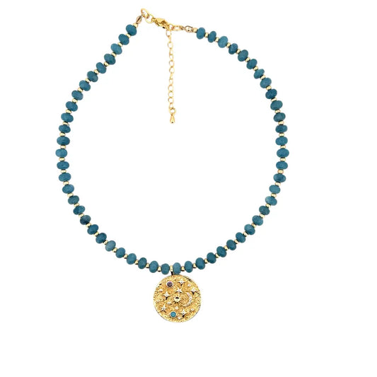 Handmade blue amethyst beaded necklace with gold celestial medallion
Blue amethyst necklace with textured gold medallion pendant
Artisan blue amethyst necklace designed by Julie Saldivia
Celestial gold medallion necklace with blue amethyst stones