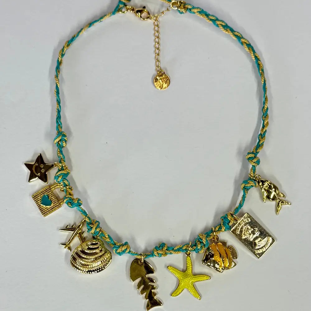 Handmade braided-cord choker with gold travel charms—airplane, starfish, palm leaf, shell—adjustable fit.