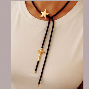 Black paracord wrap necklace designed to tie around the neck, featuring magnetic star and cross charms in 18K gold plating by Julie Saldivia