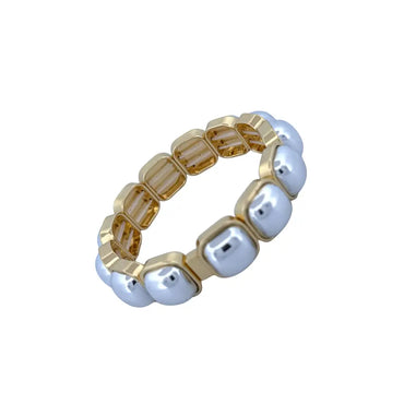 Two tone gold and silver stretch bracelet worn by model holding clutch – modern elastic statement bracelet for women
