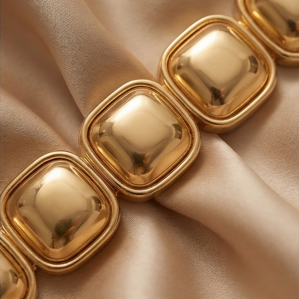 Two tone gold and silver stretch bracelet worn by model holding clutch – modern elastic statement bracelet for women