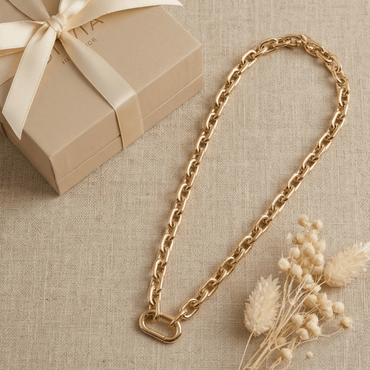 Chunky gold paperclip chain necklace displayed with gift box and neutral styling