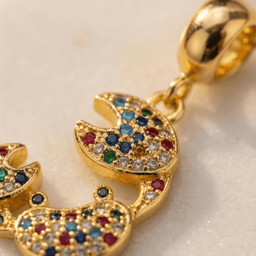 close up colorful crab pendant with multicolor stones gold detailed design