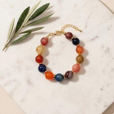 colorful-gemstone-bracelet-gold-clasp-flatlay-natural-light