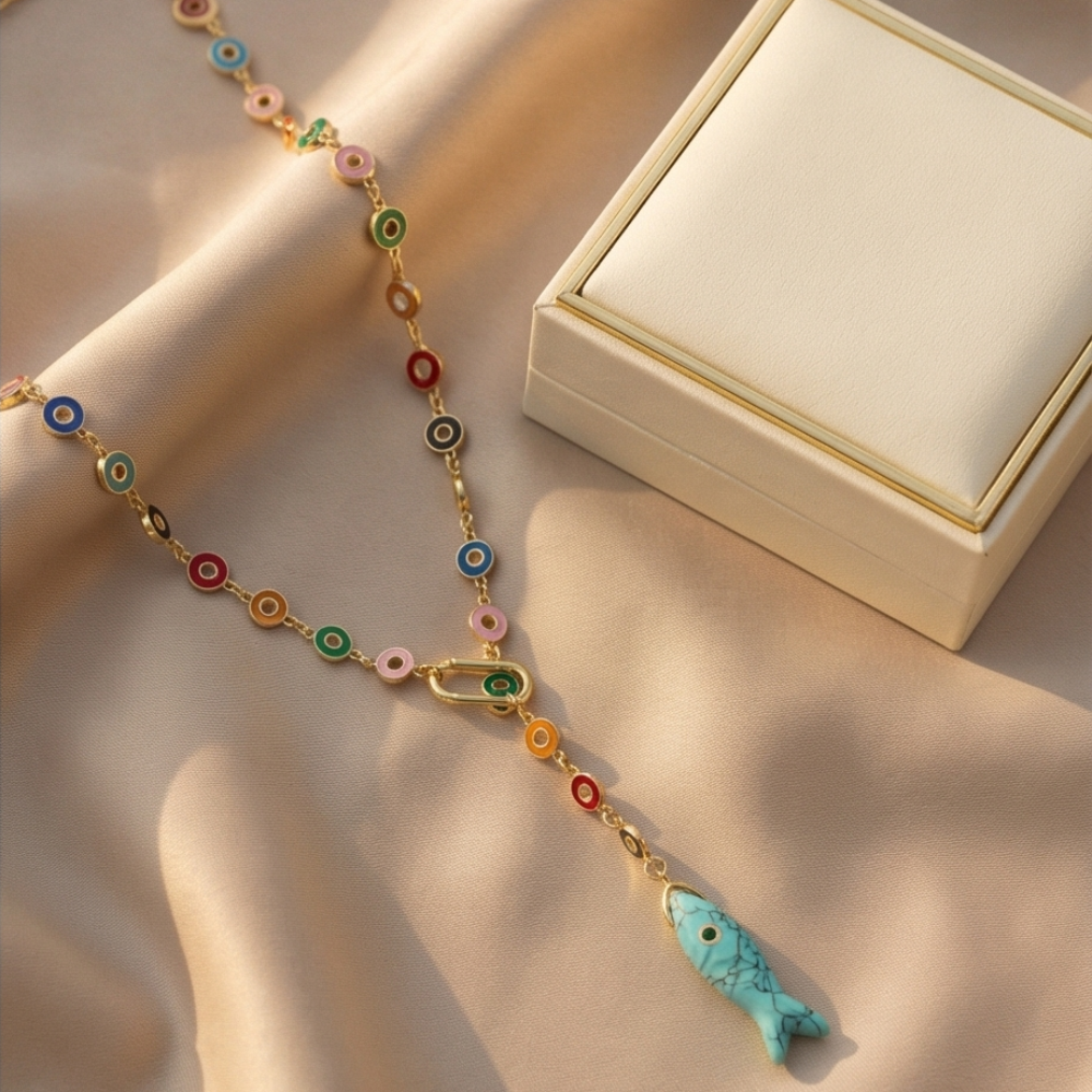 Colorful beaded necklace with a fish pendant on a beige fabric background