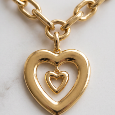 Close-up of double heart pendant on Élan Link 18K gold plated necklace