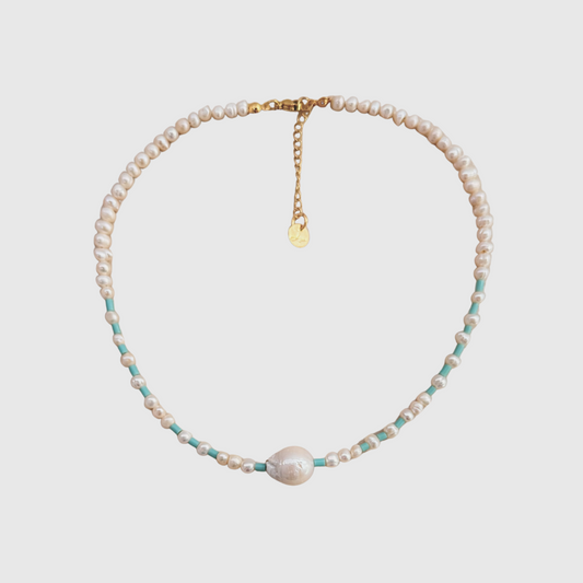 Dainty pearl choker featuring baroque center and turquoise accents with lobster clasp