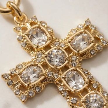 Gold cross pendant necklace with crystal stones detail close up, elegant religious jewelry for women Julie Saldivia