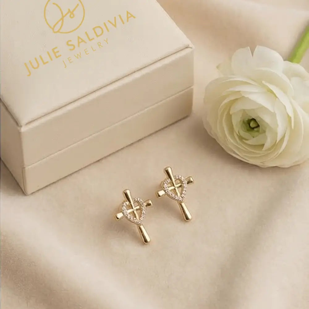 gold cross heart stud earrings flat lay with julie saldivia box elegant minimalist jewelry