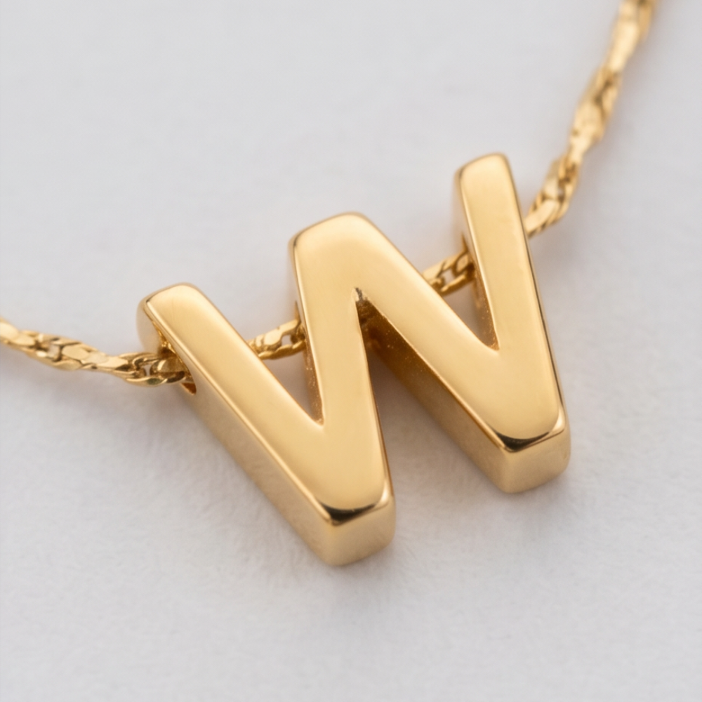 Close-up of gold double letter necklace on adjustable box chain