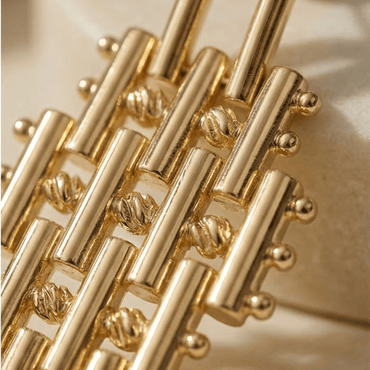 gold statement earrings close up textured geometric design luxury handmade jewelry detail