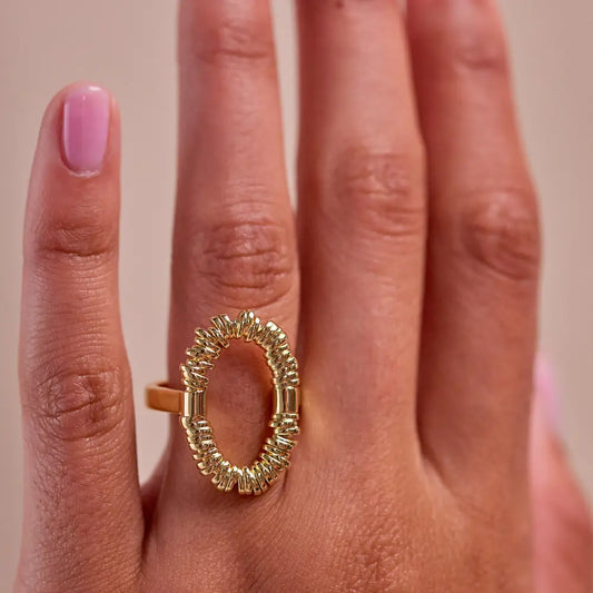 Woman wearing a gold open oval statement ring with textured detail by Julie Saldivia