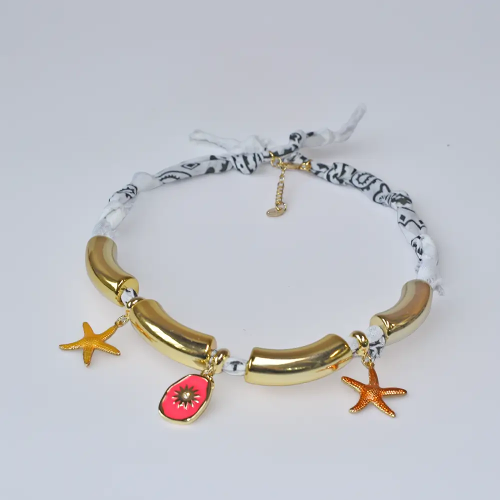 Handmade white bandana choker featuring polished gold tube segments and starfish charms.