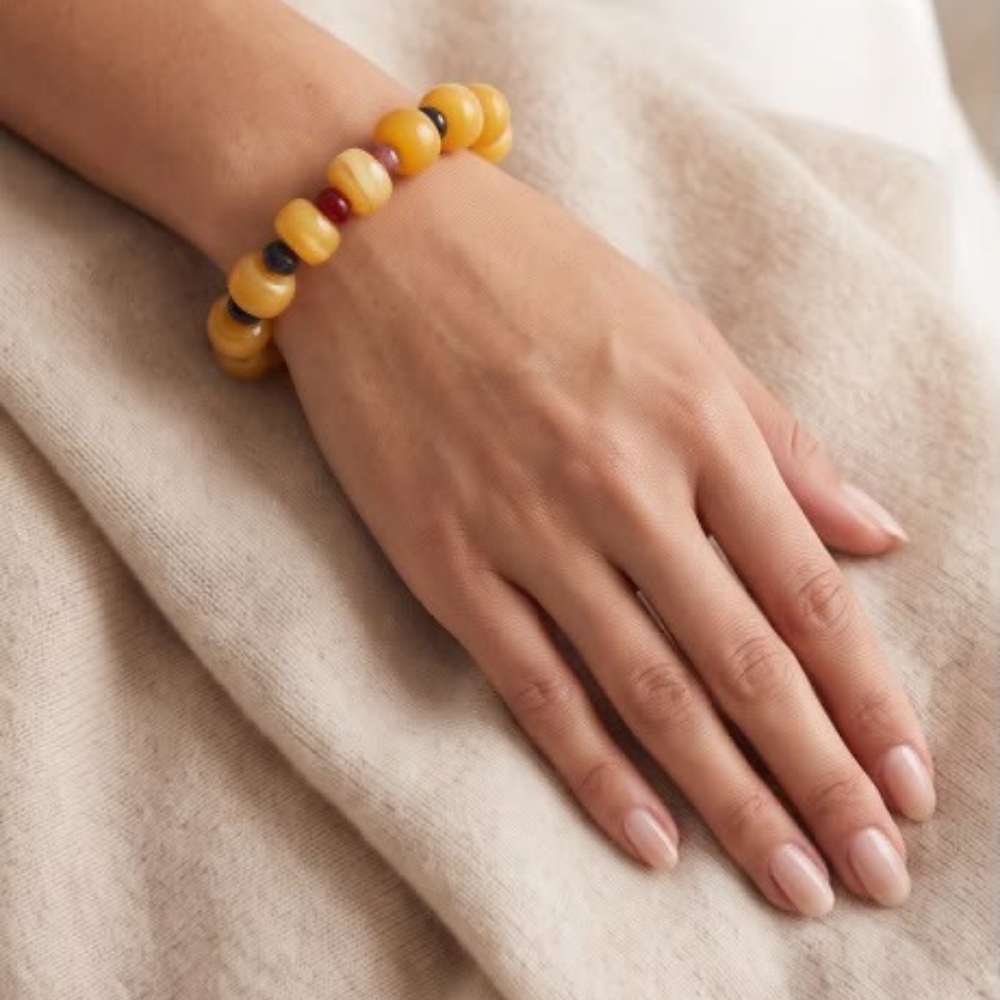 Woman wearing the Mila stretch bracelet with amber acrylic beads and natural amethyst accents from Julie Saldivia Modern Relics