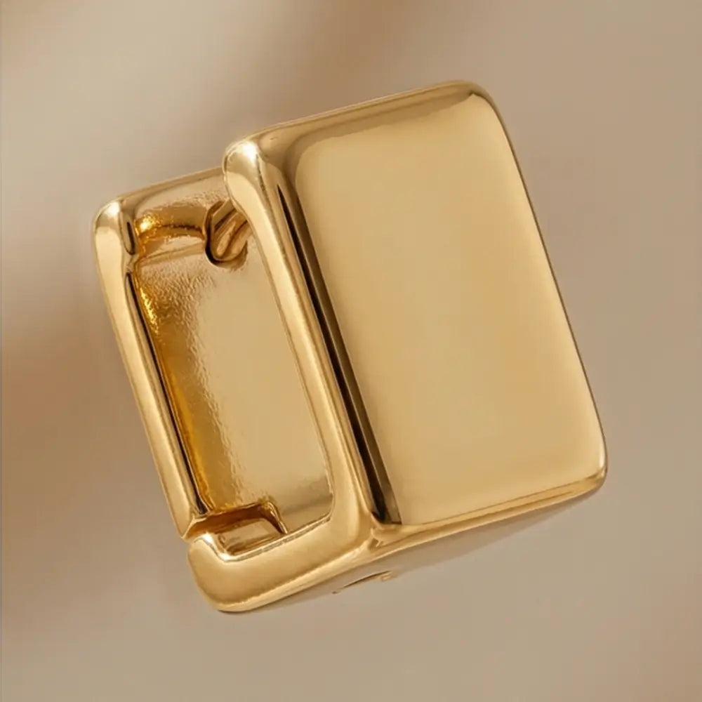 minimal gold rectangular huggie earrings close up polished finish modern design