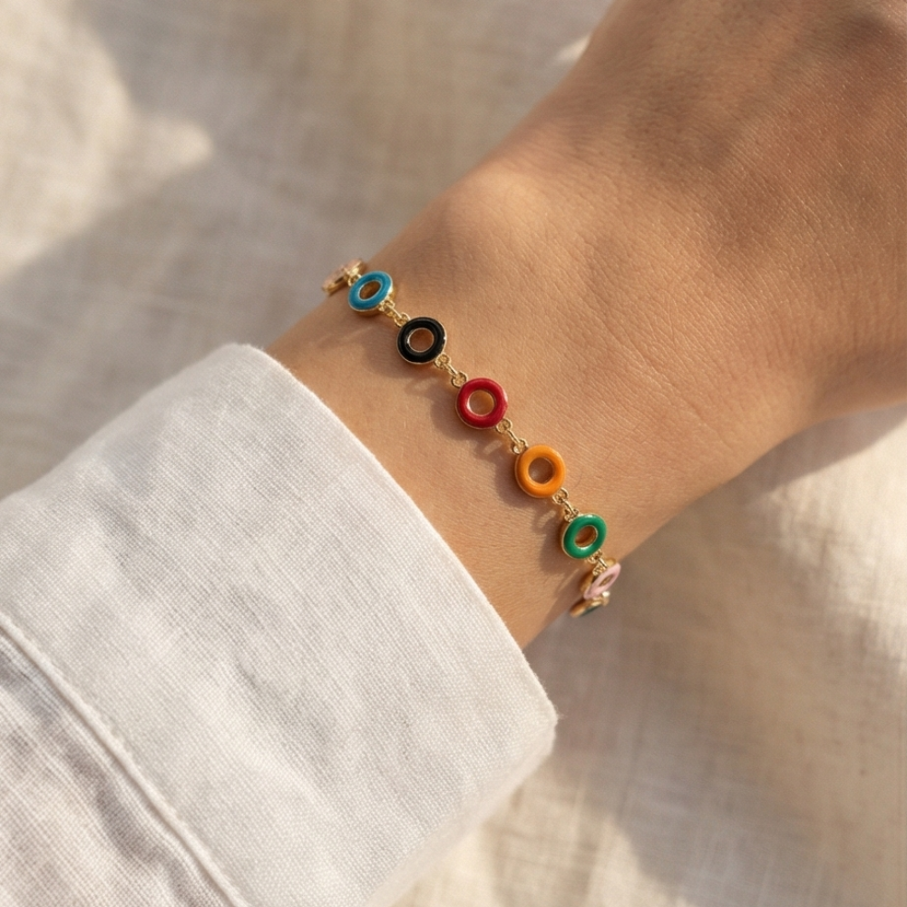 Bracelet with colorful beads on a wrist against a neutral background