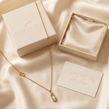 Model wearing gold tone stainless steel initial safety pin necklace