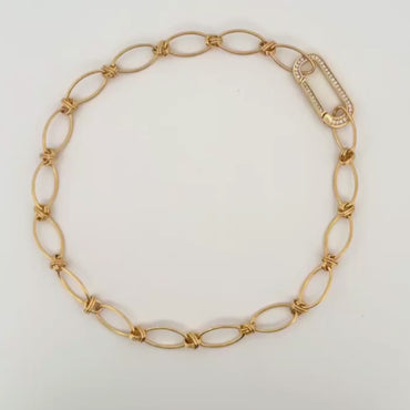 Gold oval link chain necklace with knot details and rectangular clasp, plated in 18K gold.