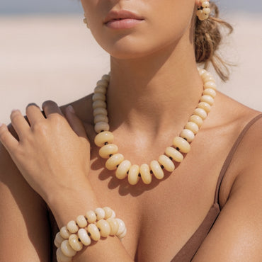 Model wearing Solene adjustable ivory donut bead necklace from the Modern Relics collection