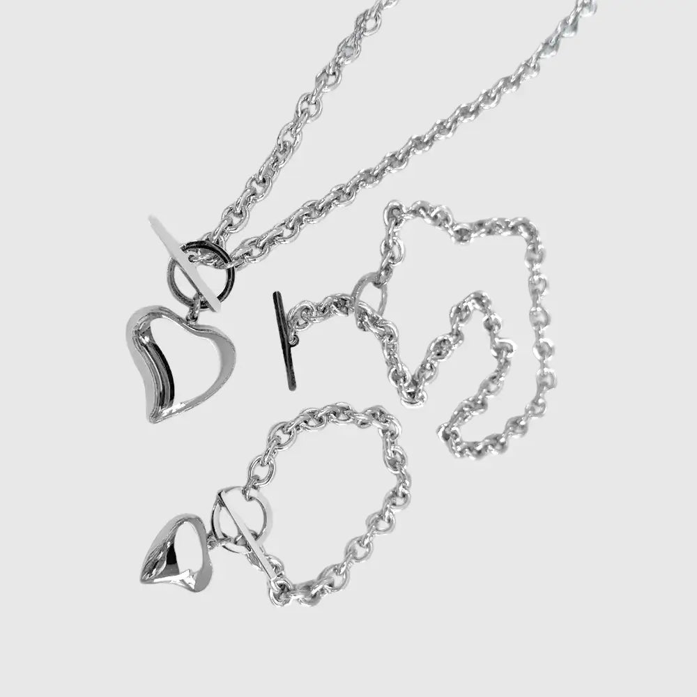 Silver heart-shaped necklace on a light gray background