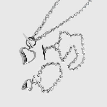 Silver heart-shaped necklace on a light gray background