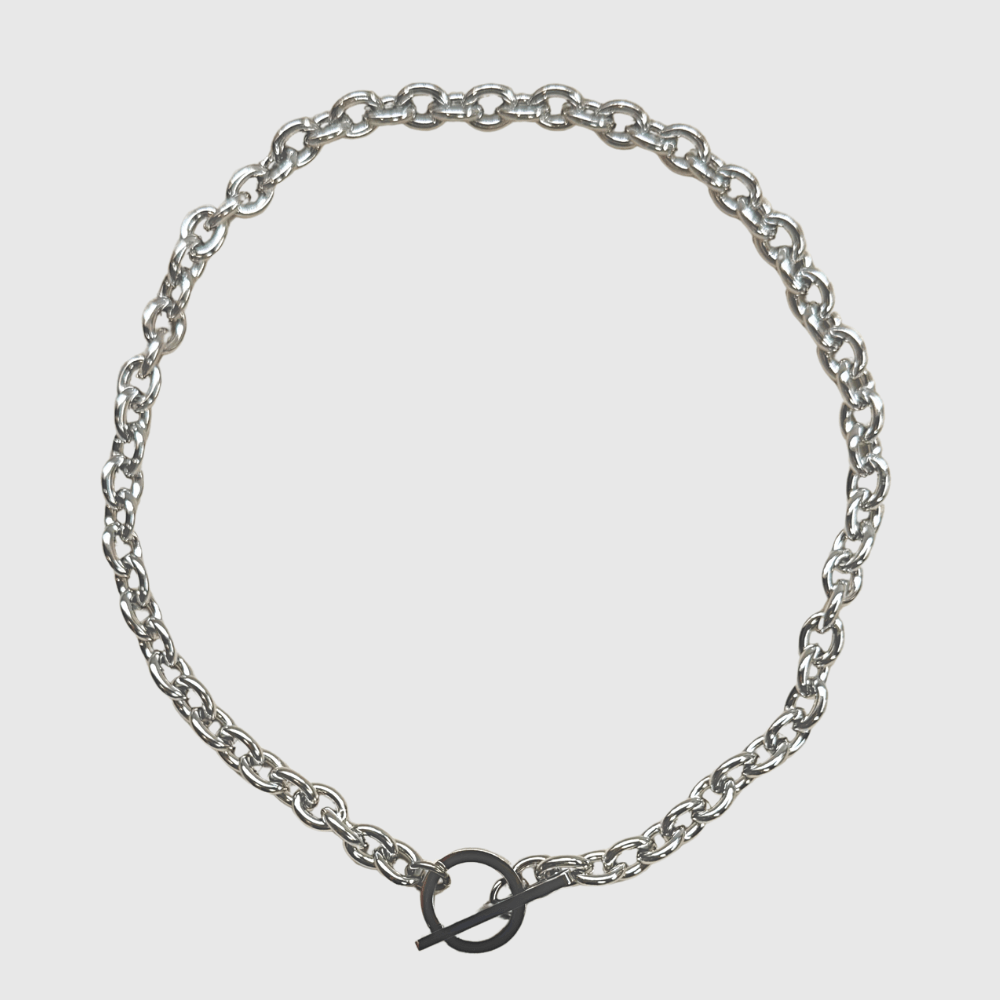 Silver chain bracelet on a light gray background