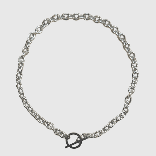 Silver chain bracelet on a light gray background