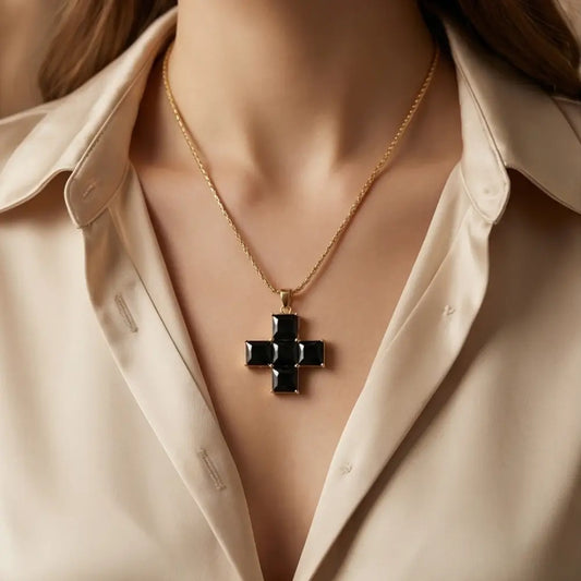 black statement cross necklace worn by woman white blouse elegant look