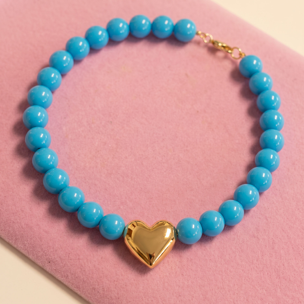 Turquoise blue beaded necklace with a polished gold puffy heart centerpiece by Julie Saldivia