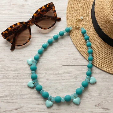 waterproof turquoise beaded necklace flat lay with sunglasses and summer accessories