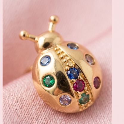 Close-up of 18K gold plated ladybug stud earrings with colorful CZ stones