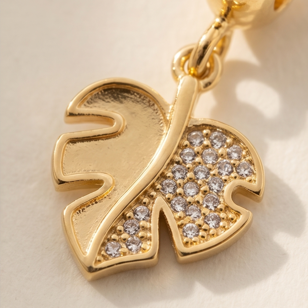 Gold pendant with diamond accents on a light background