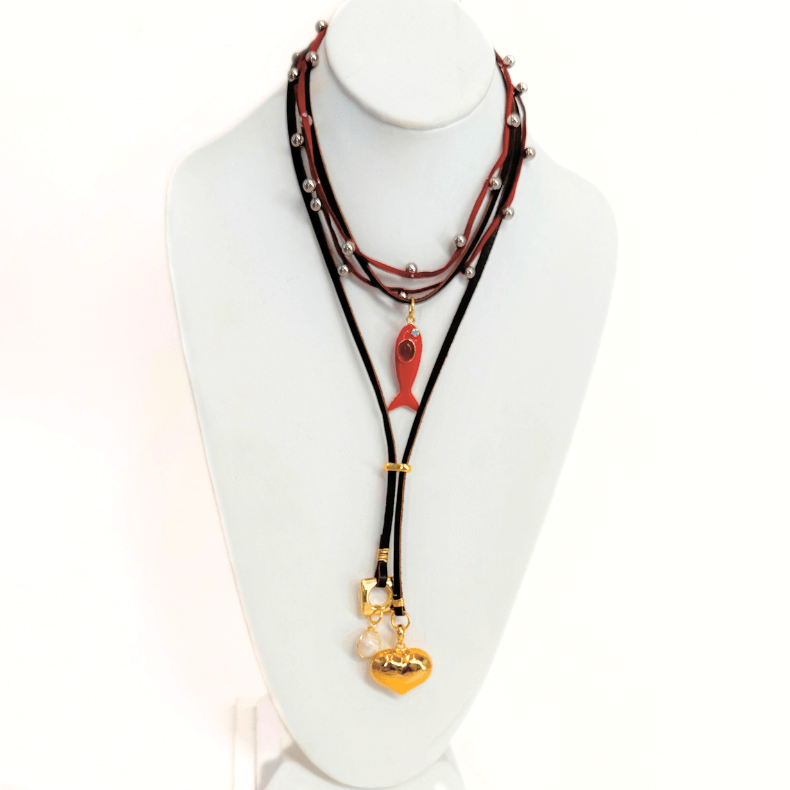 "Handmade choker necklace with layered leather cords and charms"
"Unique artisanal choker necklace with metal beads and colorful charms"
"Handcrafted choker necklace with multi-layered design and heart charm"
"Boho-inspired handmade choker necklace with fish and heart charms"
