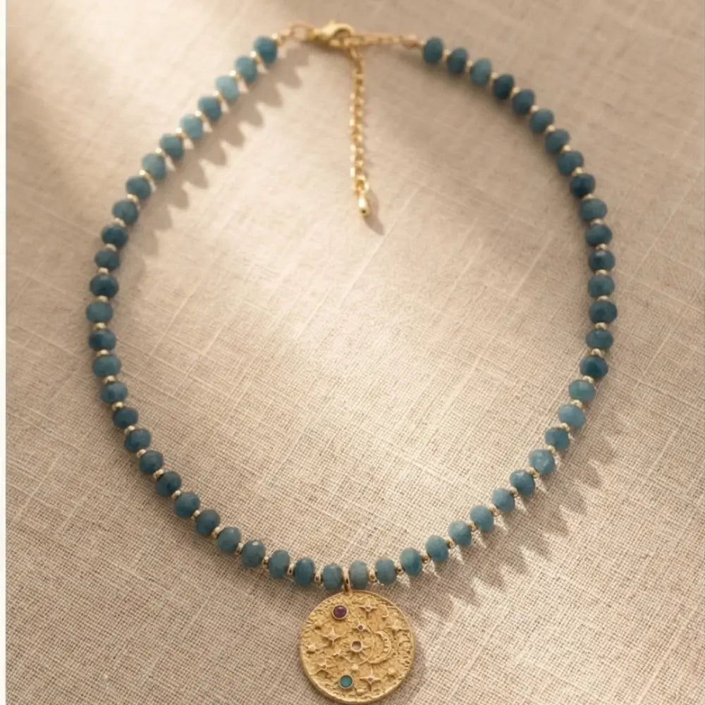 Blue Amethyst Beaded Necklace with Gold Celestial Medallion pendant on delicate blue gemstone bead chain.