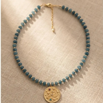 Blue Amethyst Beaded Necklace with Gold Celestial Medallion pendant on delicate blue gemstone bead chain.