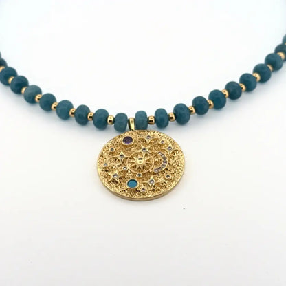 Handmade blue amethyst beaded necklace with gold celestial medallion

Blue amethyst necklace with textured gold medallion pendant

Artisan blue amethyst necklace designed by Julie Saldivia

Celestial gold medallion necklace with blue amethyst stones