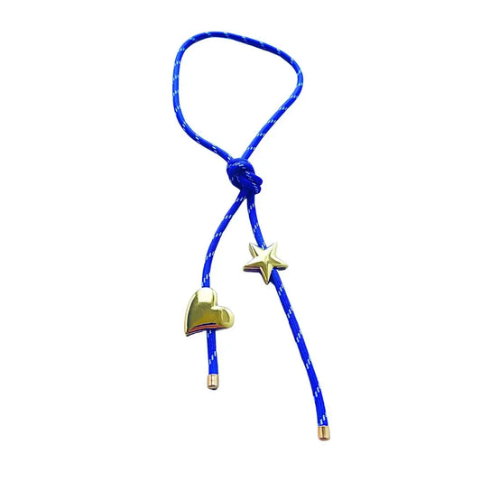 Electric blue paracord wrap necklace designed to tie around the neck, featuring magnetic heart and star charms in 18K gold plating by Julie Saldivia