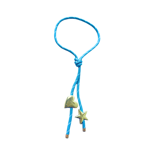 Light blue paracord wrap necklace designed to tie around the neck, featuring magnetic heart and star charms in 18K gold plating by Julie Saldivia