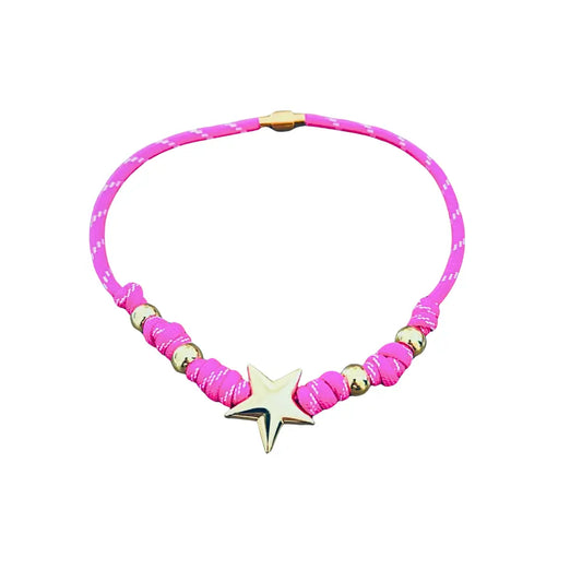 Pink paracord wrap necklace designed to tie around the neck, featuring magnetic heart and cross charms in 18K gold plating by Julie Saldivia