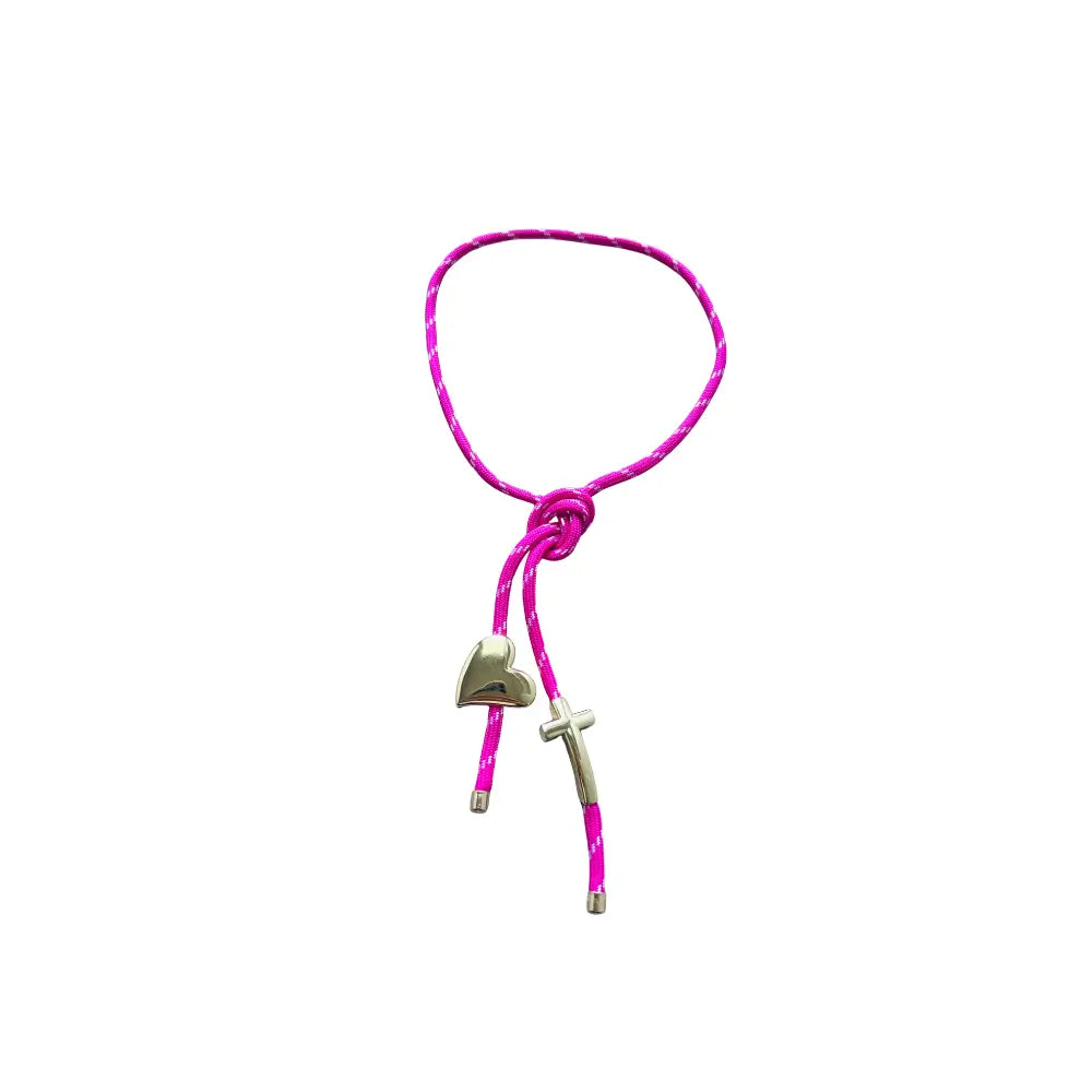 Pink paracord wrap necklace designed to tie around the neck, featuring magnetic heart and cross charms in 18K gold plating by Julie Saldivia