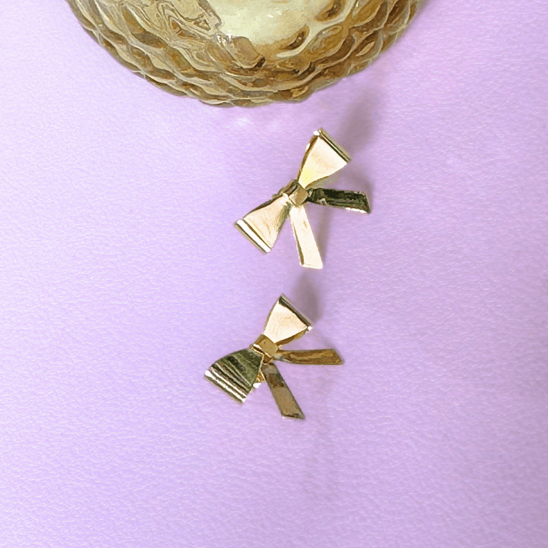 Gold bow earrings, elegant earrings, bow-shaped earrings, gold jewelry, fashion accessories, statement earrings, trendy earrings, women's earrings, gift for her