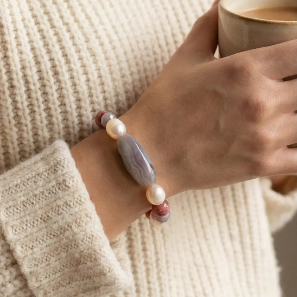 Woman wearing agate rhodonite and pearl stretch bracelet elegant jewelry
