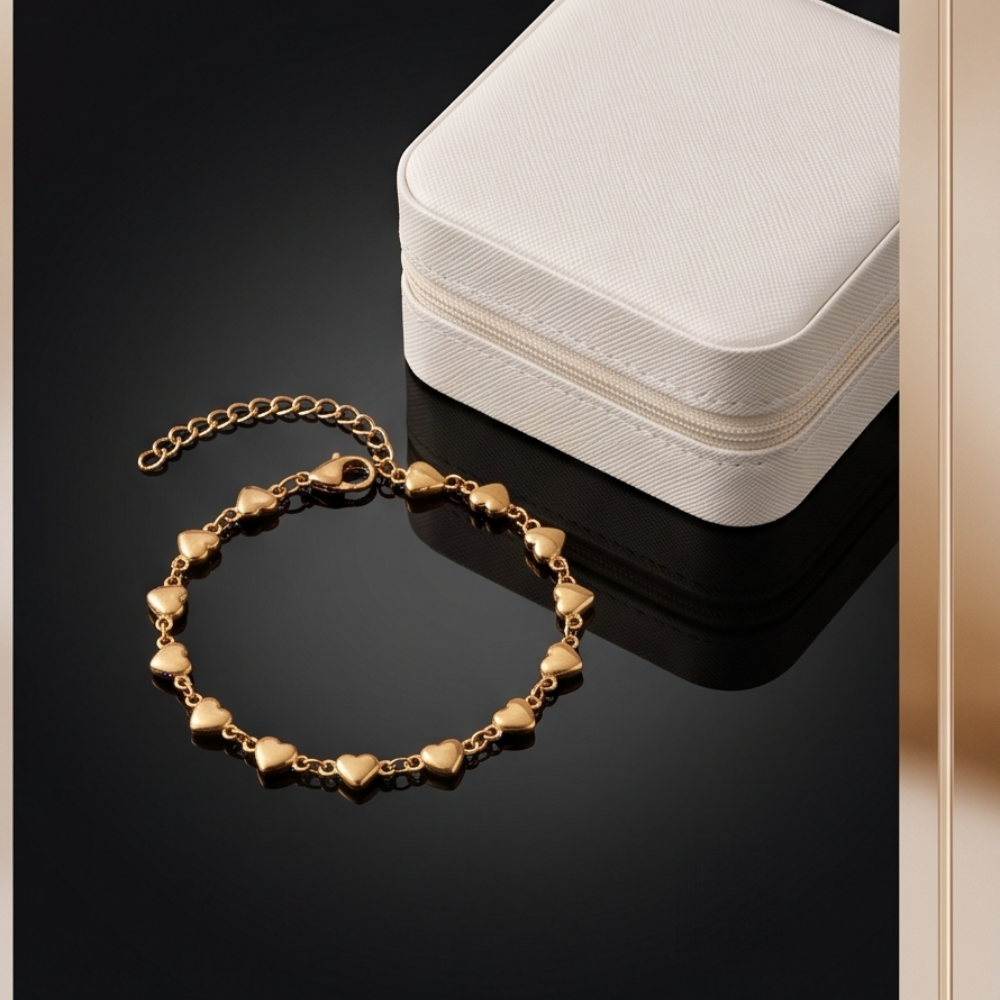 Amour dainty heart chain bracelet in gold stainless steel displayed beside jewelry case