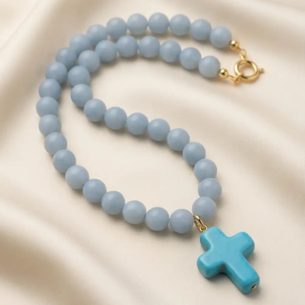 18-inch angelite stone beaded necklace with a blue enamel cross pendant and gold-tone clasp.