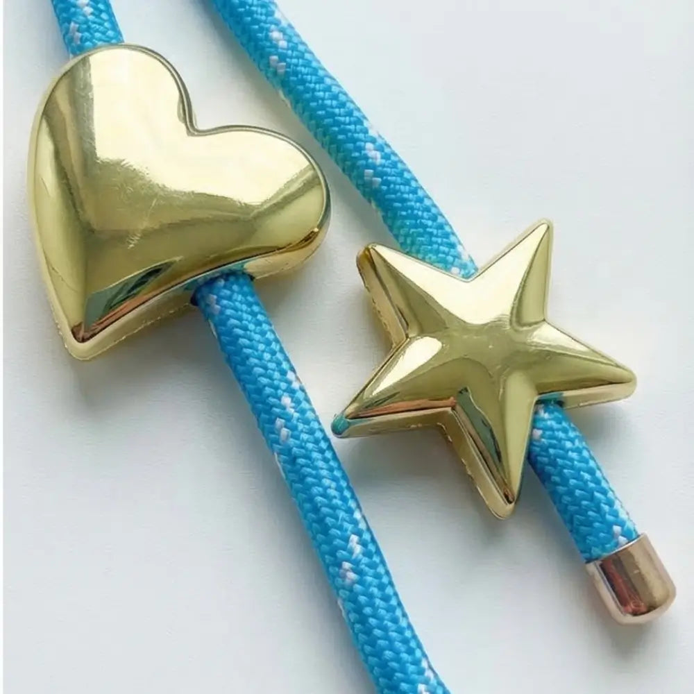 Gold heart and star-shaped ends of a blue rope on a white background