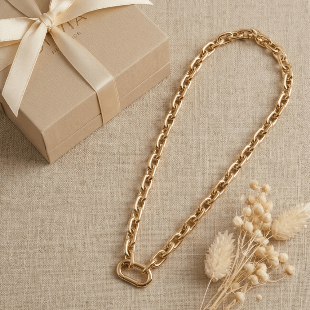 Chunky gold paperclip chain necklace displayed with gift box and neutral styling