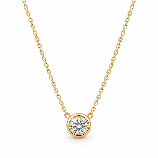 Clara Round Bezel Necklace in gold-plated sterling silver 925, featuring a sparkling clear round faceted stone in a polished gold bezel setting.