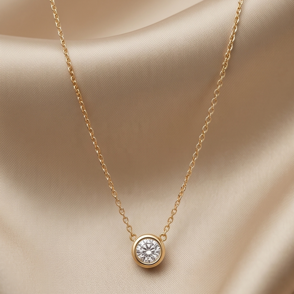Clara Round Bezel Necklace crafted in gold-plated sterling silver 925, featuring a clear faceted round stone and a 15-inch chain with extender.
