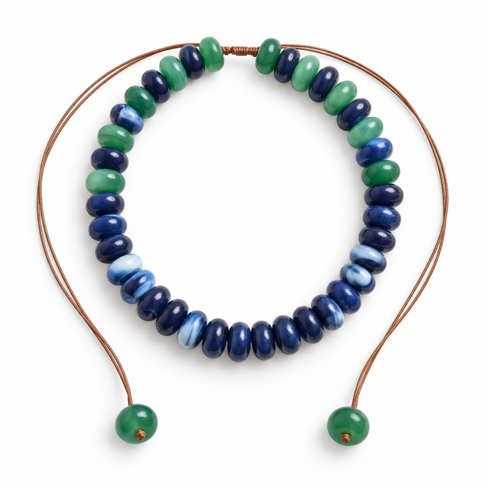 Cobalt-blue, navy and emerald-green donut bead necklace with an adjustable brown cord and green beads at both ends.