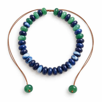 Cobalt-blue, navy and emerald-green donut bead necklace with an adjustable brown cord and green beads at both ends.